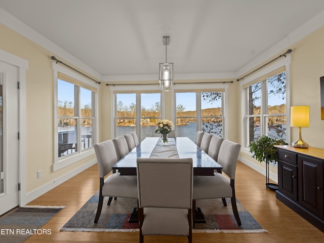 sunroom / solarium featuring a water view