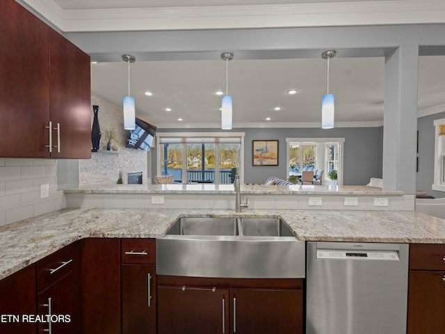 kitchen featuring pendant lighting, sink, stainless steel dishwasher, and decorative backsplash