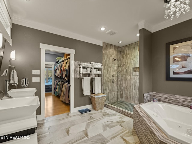 bathroom with ornamental molding, shower with separate bathtub, and vanity