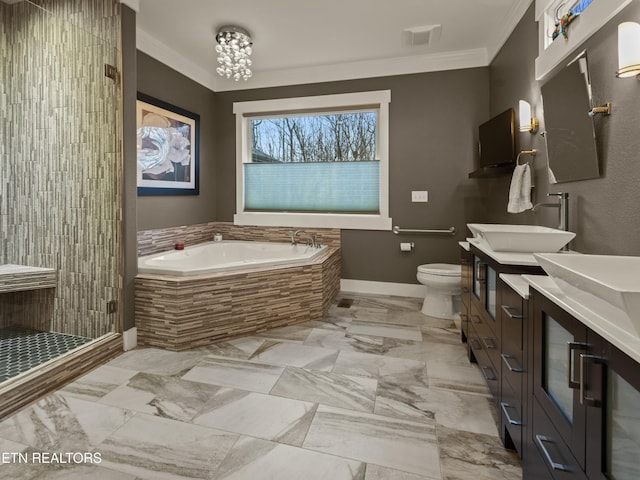 full bathroom featuring crown molding, vanity, toilet, and independent shower and bath