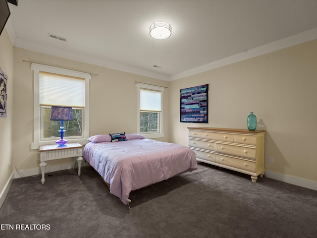 bedroom with crown molding and dark colored carpet