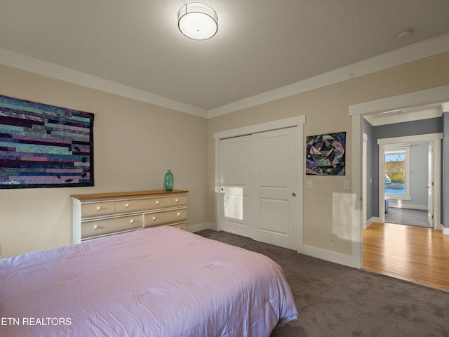 bedroom with dark carpet and ornamental molding