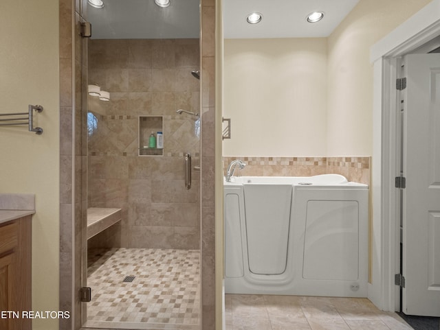 bathroom with shower with separate bathtub