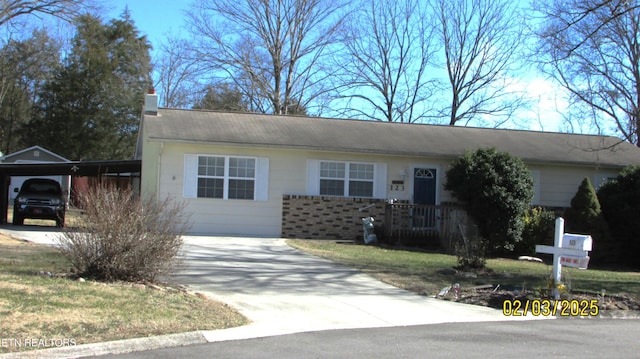 ranch-style home featuring a carport