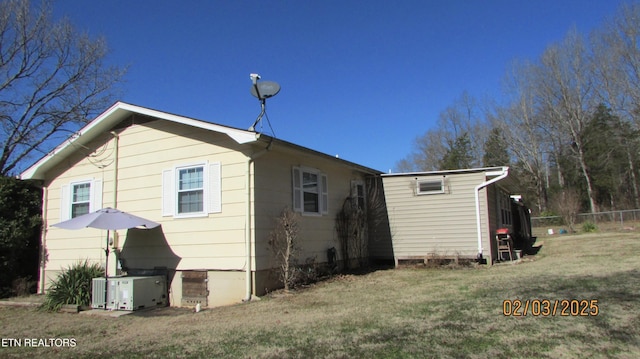 rear view of property with a yard