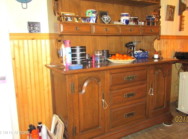 details featuring radiator heating unit and wooden walls