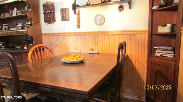 dining area with wooden walls