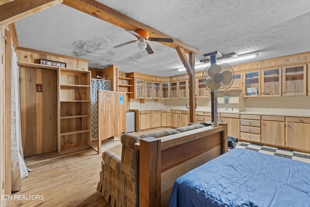 bedroom with light hardwood / wood-style floors and a textured ceiling