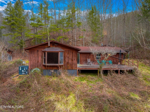 rear view of property featuring a deck