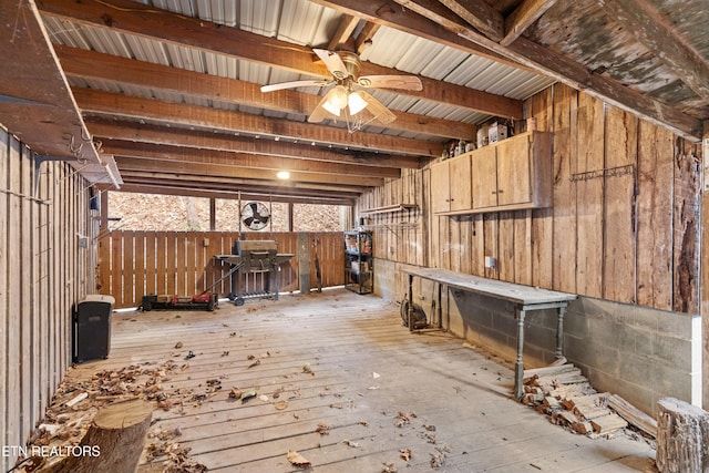 interior space featuring ceiling fan, beamed ceiling, and light wood-type flooring