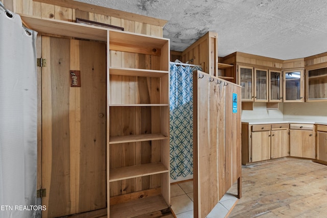 kitchen featuring light hardwood / wood-style floors and a textured ceiling