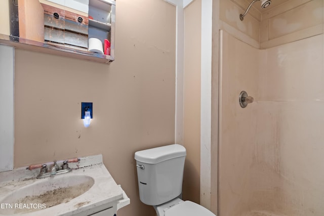 bathroom featuring vanity, toilet, and walk in shower