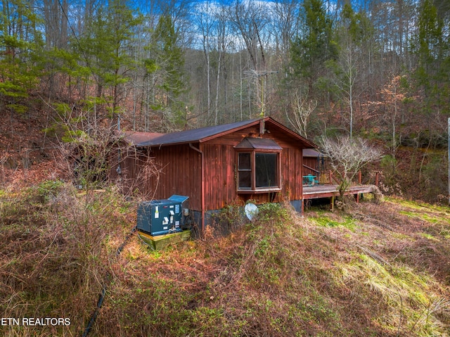 view of property exterior with a deck