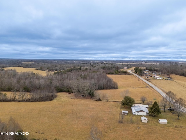 birds eye view of property with a rural view