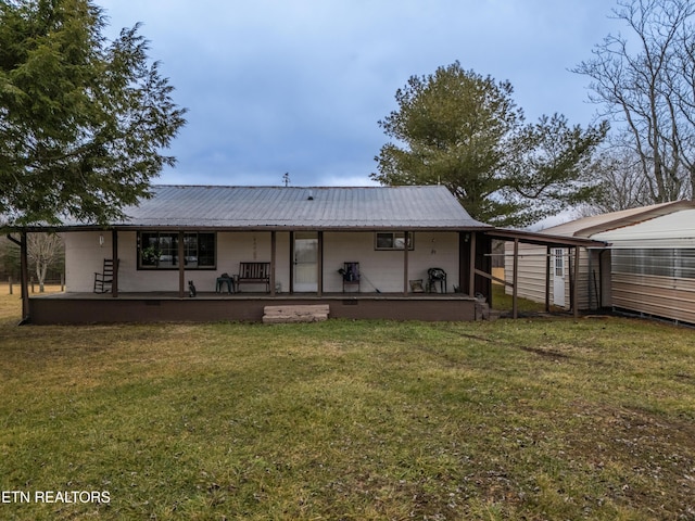 back of property featuring a yard