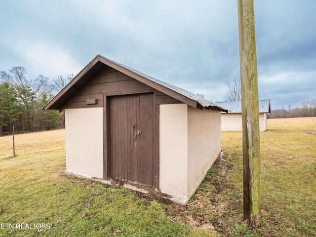 view of outbuilding with a lawn