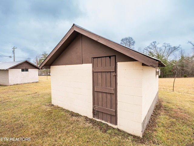 view of outbuilding featuring a yard