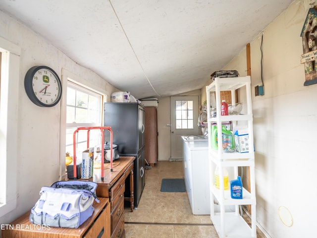 kitchen featuring lofted ceiling and stainless steel fridge