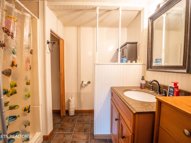 bathroom featuring walk in shower and vanity