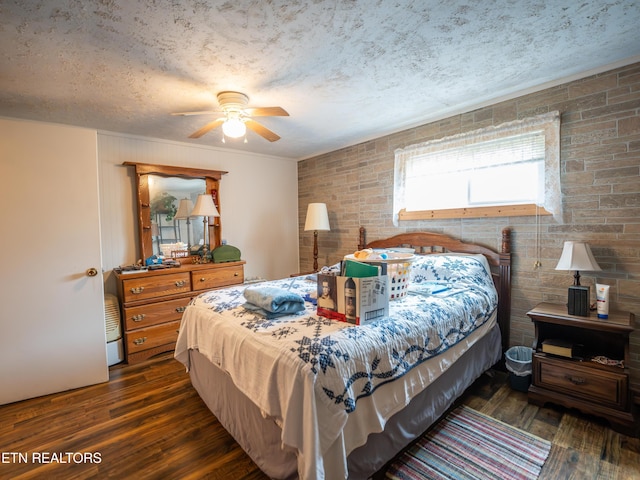 bedroom with dark hardwood / wood-style flooring and a textured ceiling