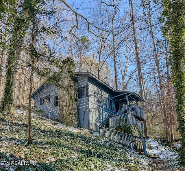 view of side of property with a balcony