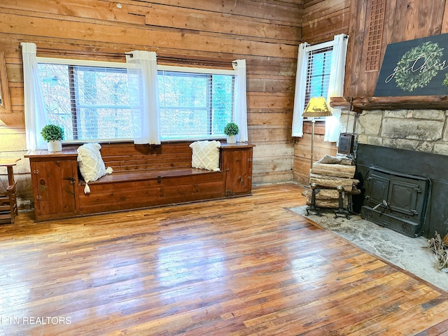 living room with hardwood / wood-style floors and wood walls