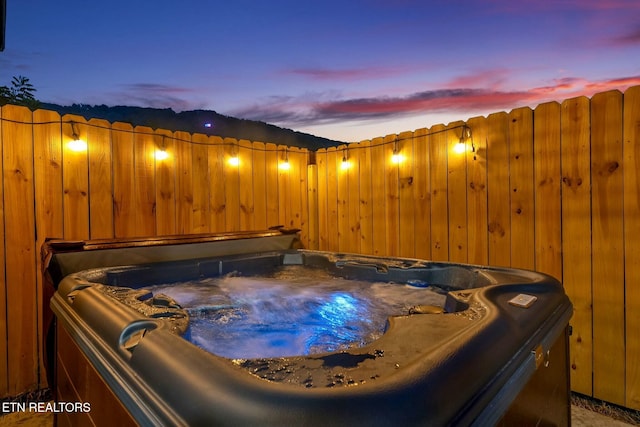 patio terrace at dusk with a hot tub