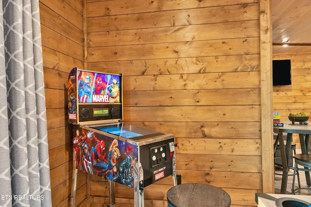 game room with wood walls