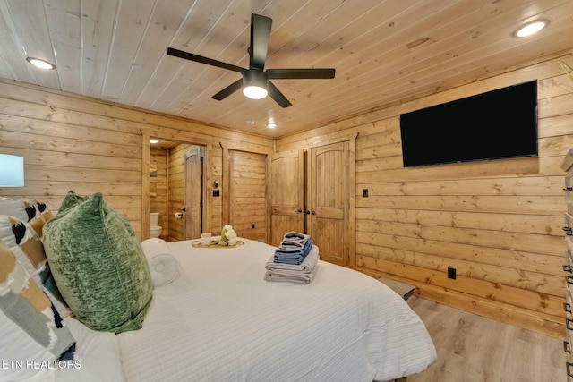 bedroom with wood ceiling, light hardwood / wood-style flooring, ceiling fan, and wood walls