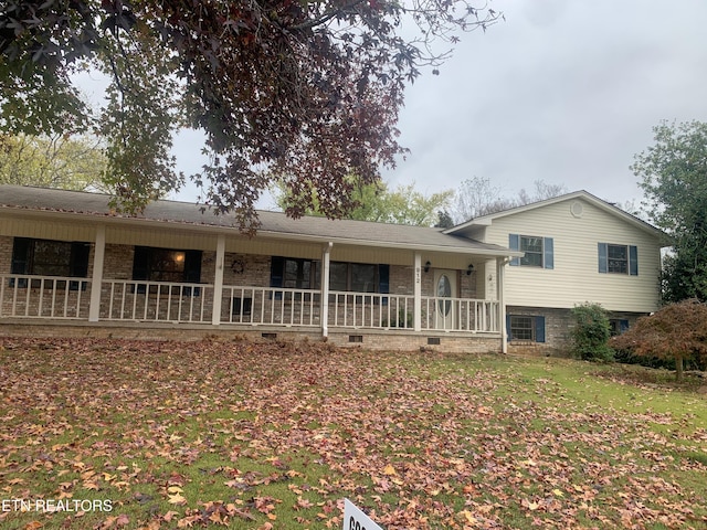 back of property featuring a porch and a yard