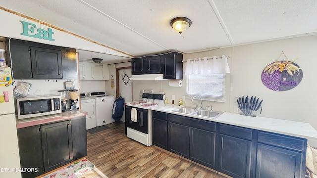 kitchen featuring washing machine and clothes dryer, sink, white refrigerator, dark hardwood / wood-style floors, and range with electric cooktop