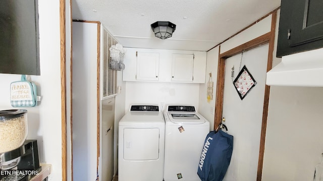 washroom with cabinets, separate washer and dryer, and a textured ceiling