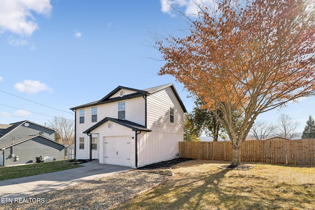 view of side of property with a garage and a lawn