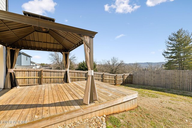 wooden deck featuring a gazebo