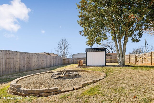 view of yard featuring a fire pit and a shed