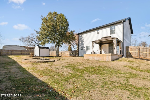 back of house with a storage shed, a gazebo, and a lawn