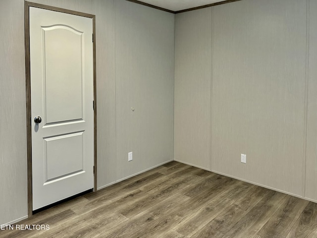 spare room with wood-type flooring