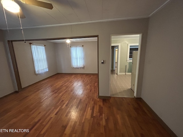 spare room with crown molding, hardwood / wood-style floors, and ceiling fan