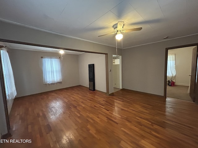 unfurnished room with hardwood / wood-style flooring, ornamental molding, and ceiling fan