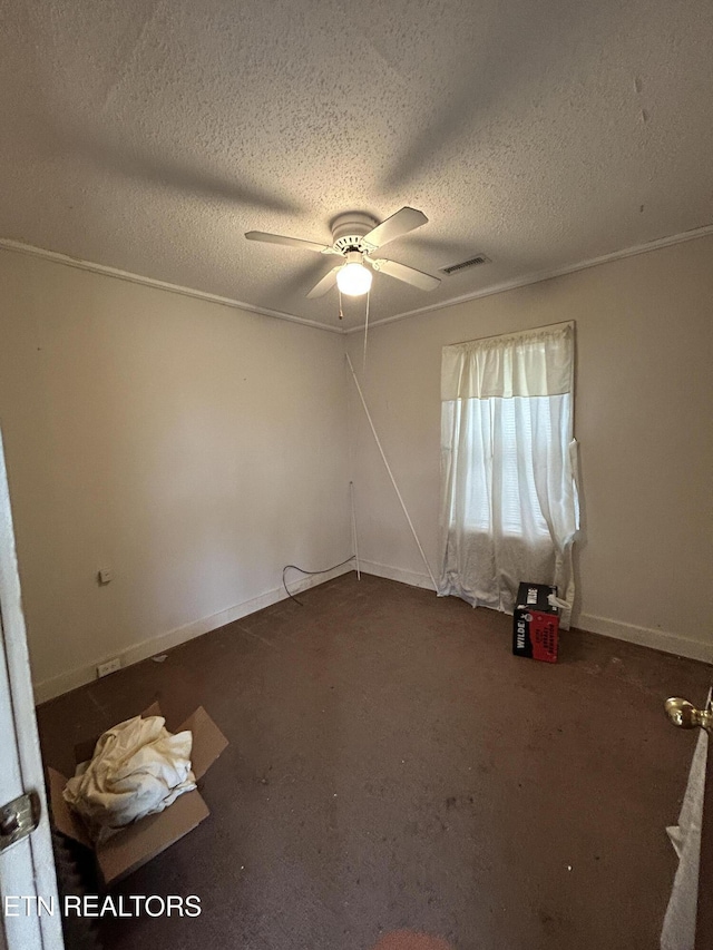 carpeted spare room with ceiling fan and a textured ceiling