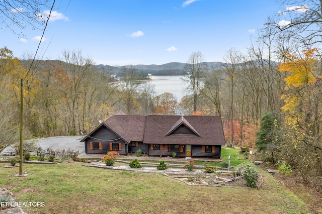 cabin with a water and mountain view and a front lawn