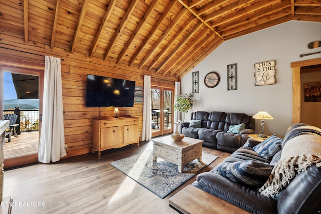 living room with wood-type flooring, lofted ceiling with beams, wooden ceiling, and wood walls