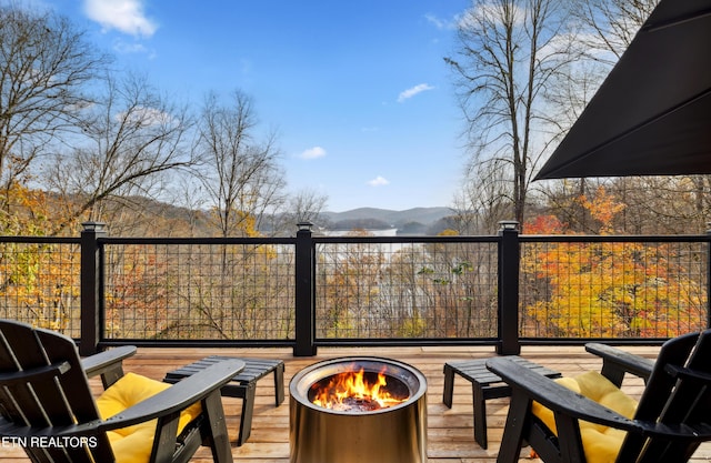 deck featuring a mountain view and a fire pit