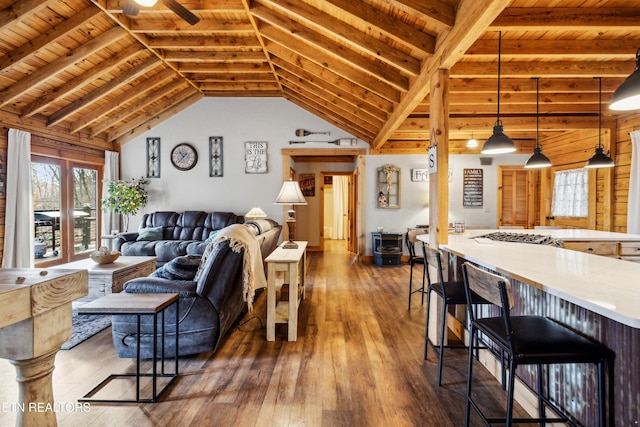 living room featuring vaulted ceiling with beams, wood ceiling, and dark hardwood / wood-style flooring