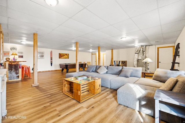 living room featuring a drop ceiling, light wood-type flooring, and billiards