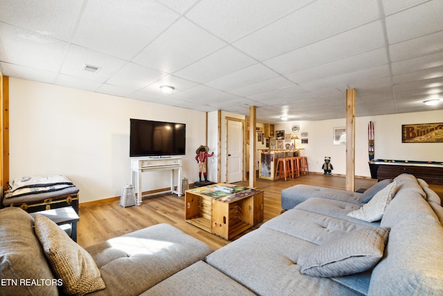 living room with wood-type flooring, a paneled ceiling, and pool table