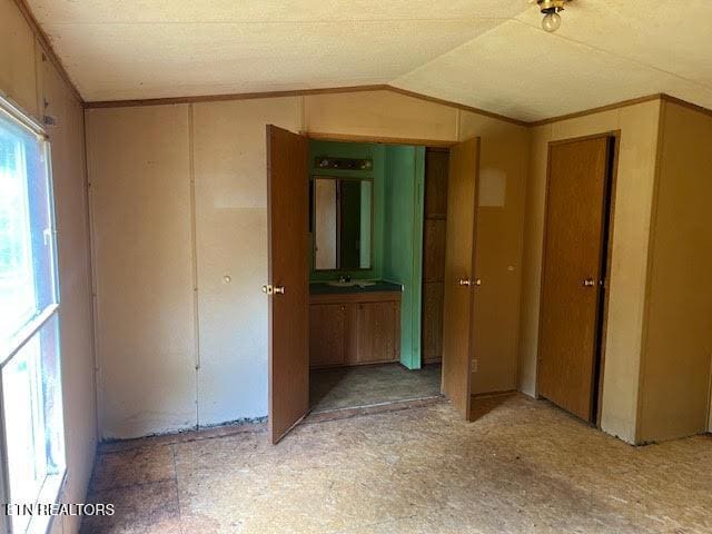 interior space featuring lofted ceiling and ornamental molding