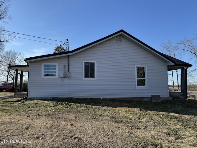 view of property exterior with a lawn