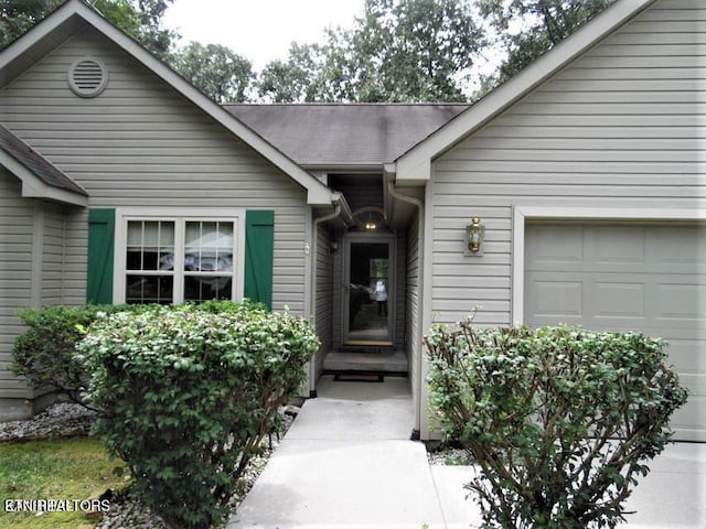 doorway to property with a garage