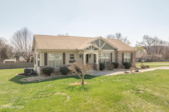 view of front of home with central AC and a front lawn